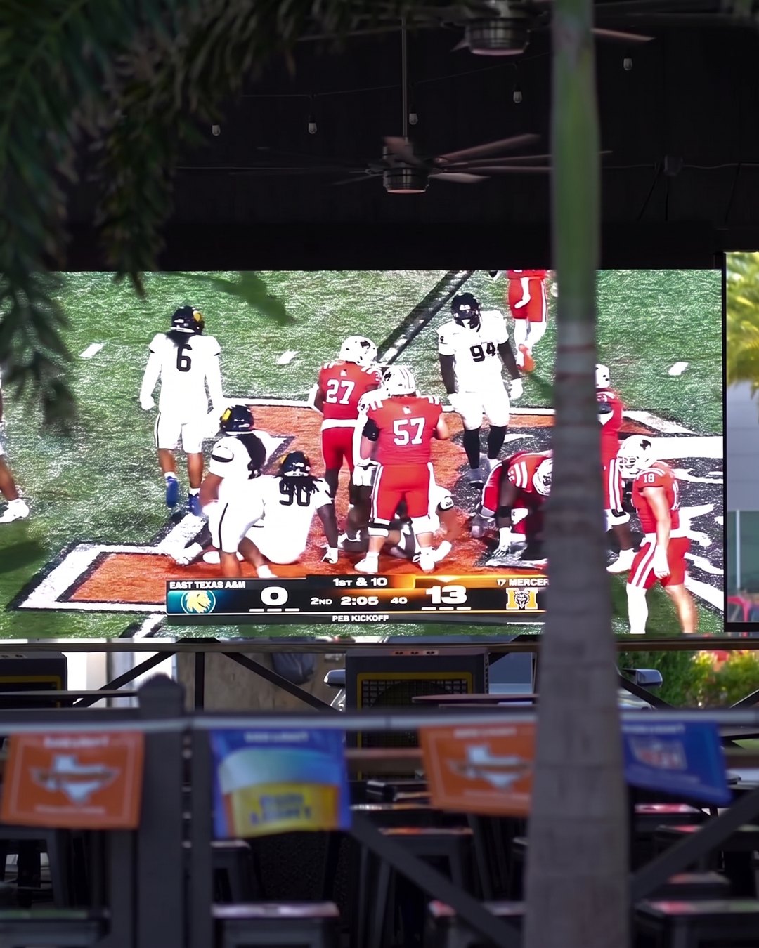 The SKYBOX patio with its own big screen showing a football game