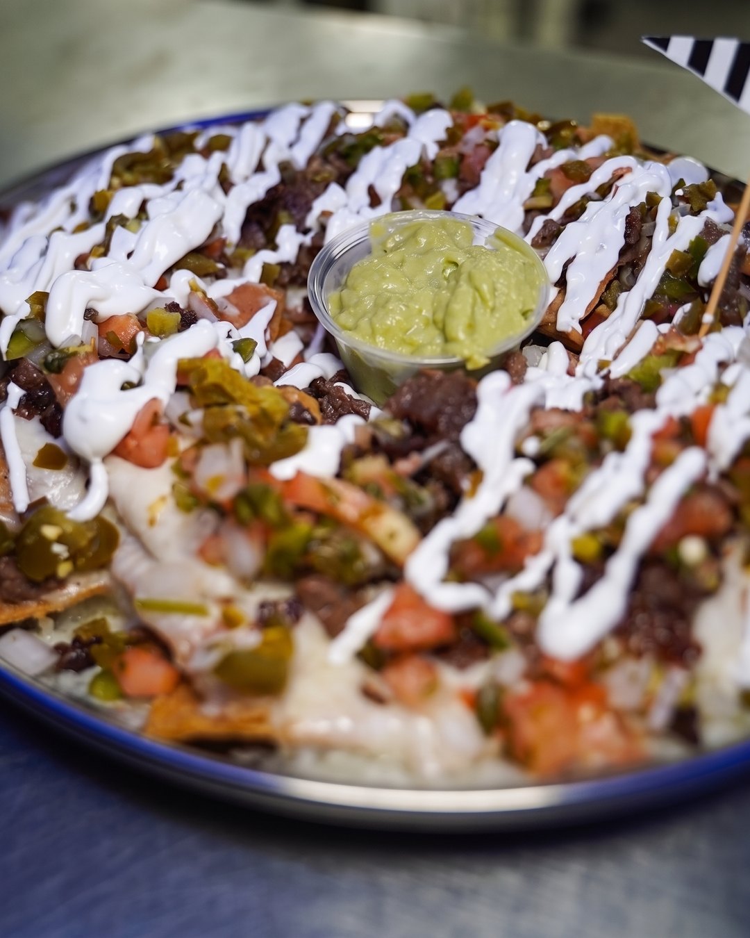 Skybox Mega Nachos with Carne — crema, jalapeños, pico and guacamole