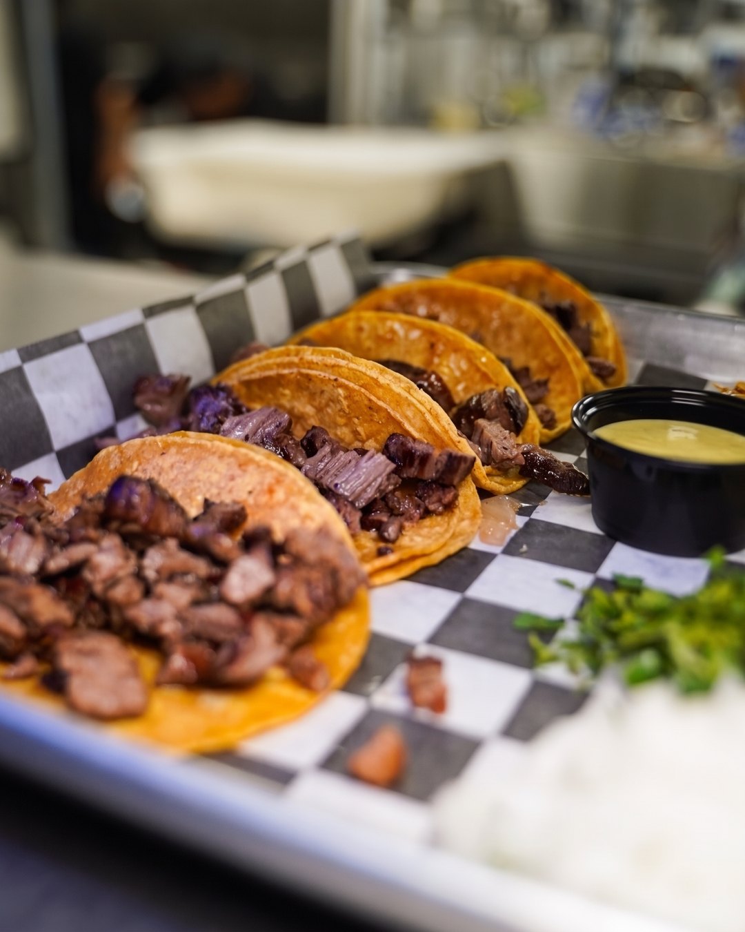 Street-style bistec tacos with salsa, cilantro and onion